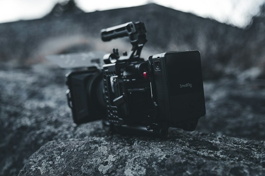 Professional camera and press pass on a dark table